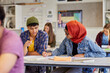 © Rido - Teen students collaborating in class at high school