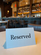© Lauren - Reserved sign on restaurant table with bar background