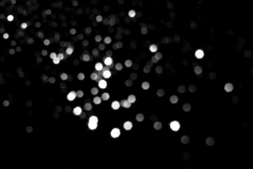 Wall Mural - White gray blurred bokeh lights on black background. Glitter sparkle stars for celebrate. Overlay for your design