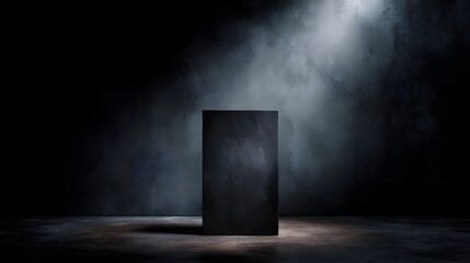 Wall Mural - A dark textured pedestal is dramatically lit by a spotlight in a minimalist shadowy studio setting