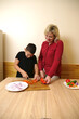 © Vasyl - A mother and her son prepare a pita bread roll for a holiday dinner.