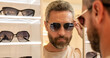 © be free - Trendy sunglasses accessories for men. Eyewear collection. Fashion look with sunglasses. Man choosing sunglasses in shop. Sunglasses model in fashion store. Fashionable man go shopping