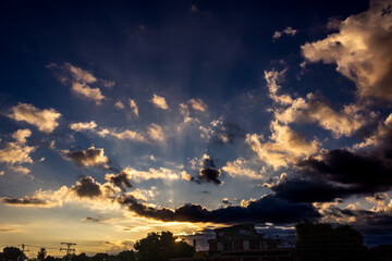 Wall Mural - Sunset sky with clouds and sunbeams