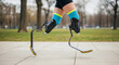 © Q-Zack - A disabled man with a prosthetic j-shaped running blade legs on blurred park track background. Running rehabilitation, jogging, para sports concept. Lifestyle shot for poster