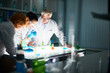 © pressmaster - Side view of inspired microbiologists on the way toward new discovery. Young specialists guided by experienced scientist carrying out experiment in laboratory