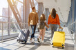 © Anastasiya - European family walking together at airport corridor with luggage, holding hands and smiling, showing cheerful lifestyle, bonding, unity and joyful holiday departure
