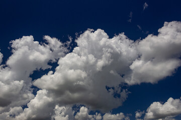 Wall Mural - Blue sky background with white clouds. Cumulus white clouds in the blue sky.