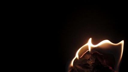Burning paper, glowing edge of paper on a black background. Mockup for your logo. Wide angle horizontal wallpaper or web banner. flame effects for overlay designs or screen blending mode to make high.