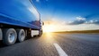 © Johnny - blue truck driving on the asphalt road on a horizon against the glowing sun