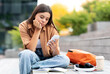 © Prostock-studio - Upset pretty young woman student sitting on stairs on street at park, looking at phone screen, waiting for call or message from lover, feeling lonely, copy space. Communication concept