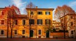 © ties.studio - Charming Italian Building with Autumn Trees and Vibrant Colors in Rome.