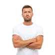 © arthit - Thoughtful young man with arms crossed posing confidently in casual white shirt isolated on white background