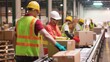 © baoxiangbin - Employees Wearing Safety Vests and Hard Hats Carefully Handle Packages on a Warehouse Conveyor Belt, Ensuring Efficient, Secure, and Orderly Logistics Operations in the Warehouse Environment