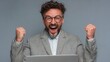© Crocodilchik - Excited young businessman working in modern office