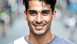 © Bejo - Close-up portrait of a smiling young man with dark hair and eyes, outdoors with a blurred background
