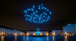 © Umer - Spectacular drone light show illuminates night sky above historic city square