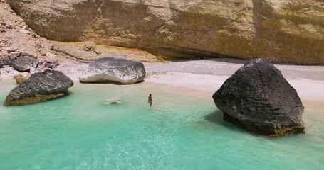 Wall Mural - Female Tourist On Holiday In Turquoise Waters Of Shoab Beach In Qalansiyah, Yemen. Aerial Shot