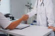 © crizzystudio - Doctor shaking patient's hand after successful medical treatment