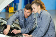 © auremar - portrait two positive workers fixing car to satisfied client