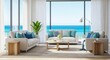 © Alice O - Modern coastal living room with white sofas, blue pillows, and wooden coffee table. Large windows showcase ocean views with natural light streaming through curtains. Green plant adds freshness.