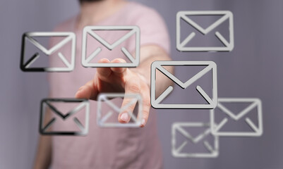 Person interacting with email symbols on a screen.  Concept of communication and technology.