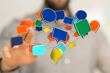 Man pointing at a network of colorful speech bubbles, representing modern communication and social media.