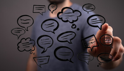 A man interacts with digital speech bubbles, representing connection, communication and technology, conveying message. Social media concept