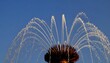 © Satu - Water jets arc gracefully from a fountain's top against a clear blue sky