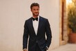 © Andrei - Stylish man in formal attire confidently walks along charming st