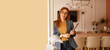 © Moon Safari - Portrait of female financial advisor in eyeglasses holding laptop and leaning confidently on wall in office