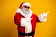 © deagreez - Santa Claus in vibrant sunglass showing finger guns with cheerful expression against a bold yellow backdrop