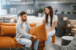 © Serhii - Couple choosing couch in furniture showroom