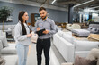 © Serhii - Woman buyer talking with sales consultant in furniture store