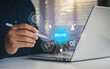 © LAONG - Brand awareness strategy concept, businessman touch digital brand awareness icons, communication, target, Marketing growth, customer loyalty, and partnership symbols for corporate branding success