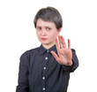 © 1STunningART - Woman outstretching her arm ahead showing stop gesture with her palm, symbol for prohibition, no sign, looking at serious to camera isolated on transparent background. Rejection or refusal concept