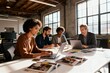 © Dmitry - Creative team collaborating around layouts in loft
