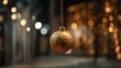 © Oleh - Golden glittering christmas ornament hangs against a soft, out of focus background of warm holiday lights, creating a sparkling bokeh effect full of festive glow and seasonal magic