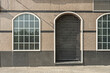 Small business with a vintage-style facade and glass partitions divided into small traditional squares