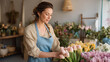 © AllieGraphix - A confident female florist arranging tulips in a boutique flower shop.