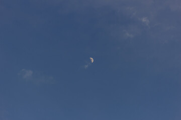 Wall Mural - Moon in the blue sky with white clouds, 