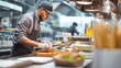 © vetrana - Busy chef prepares meals in fast food kitchen during lunch rush, focusing on fresh ingredients and quick service