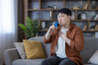 © Liubomir - Asian man using inhaler battling asthma attack