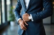 © starush - Businessman adjusting suit jacket in modern office environment