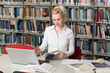 © Jale - Student Using Her Laptop in a Library