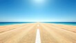 © tanatip - Endless Journey A straight desert road stretches towards the ocean horizon under a clear blue sky, symbolizing freedom and travel