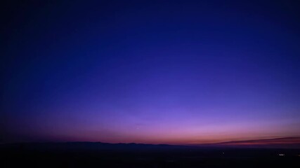 Wall Mural - Deep twilight colors saturate the expansive sky, transitioning from blue to purple and dark, starless hues mystery, blue, tranquil