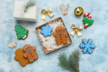 Wall Mural - Gift box with sweet gingerbread cookies and Christmas decorations on light blue background