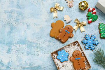 Wall Mural - Gift box with sweet gingerbread cookies and Christmas decorations on light blue background