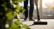 © MdNazim - Person vacuuming carpet with cordless cleaner vacuum cleaner