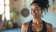 © Su Young Moon - Young Latin female yoga coach smiling in a yoga gym studio.